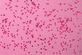 Pink hearts glitter on pink backdrop. Decorative Christmas and New Year party background. Festive template. Greeting