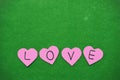 Pink hearts with the word love being arranged