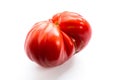 Pink heirloom tomato also called heritage tomato on white background. Natural, homegrown, imperfect tomatoes. Royalty Free Stock Photo