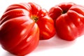 Pink heirloom tomato also called heritage tomato on white background. Natural, homegrown, imperfect tomatoes. Royalty Free Stock Photo