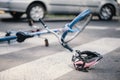 Pink helmet and blue kid`s bike on pedestrian crossing after inc
