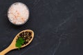 Pink Himalayan salt on the wooden spoon and mix of peppers in a glass bowl Royalty Free Stock Photo