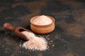 Pink himalayan salt in wooden bowl on black background Royalty Free Stock Photo