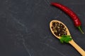 Pink Himalayan salt on the wooden spoon and mix of peppers in a glass bowl Royalty Free Stock Photo