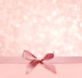 Pink holiday bokeh background with silk bow