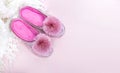 Pink home velvet slippers and white plaid on a pink background Royalty Free Stock Photo