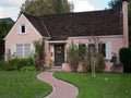 Pink house and brick trail Royalty Free Stock Photo