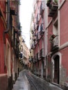 Pink houses of Cagliari. Long city street leading to the sea.