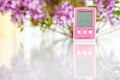 Pink hygrometer on white table with lilac background Royalty Free Stock Photo