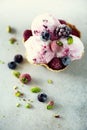 Pink ice cream with berries, strawberries, blueberries, raspberries, pistachios in waffle basket. Summer food concept Royalty Free Stock Photo