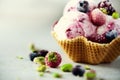 Pink ice cream with berries, strawberries, blueberries, raspberries, pistachios in waffle basket. Summer food concept Royalty Free Stock Photo