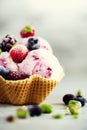 Pink ice cream with berries, strawberries, blueberries, raspberries, pistachios in waffle basket. Summer food concept Royalty Free Stock Photo