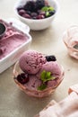 Pink ice cream scoops in glass bowl, close up. Homemade healthy sorbet with banana and berry, icecream refresing treat