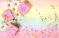 Pink iced cakes with sprinkles on a colourful background