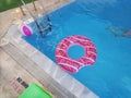 Pink inflatable circle-donat close-up on the surface of the pool