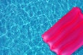 Pink inflatable pillow on the surface of the water in the pool Royalty Free Stock Photo