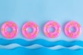 Pink inflatable pool floats and waves made of paper abstract Royalty Free Stock Photo