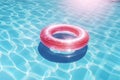 a pink inflatable ring floating on the surface of water in swimming pool, summertime, outdoor activity, sport, vacation concept Royalty Free Stock Photo