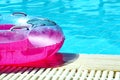 Pink inflatable round tube in swimming pool Royalty Free Stock Photo