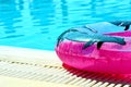 Pink inflatable round tube in swimming pool Royalty Free Stock Photo