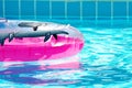 Pink inflatable round tube in swimming pool Royalty Free Stock Photo