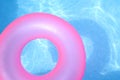 Pink inner tube on blue water Royalty Free Stock Photo