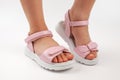 Pink insulated sandals. Children& x27;s pink sandals with white soles and Velcro fasteners on a white background
