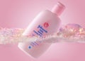 Pink Johnson`s baby lotion swimming in foamy water. Skin care moisturizing product in plastic bottle. Baby skincare product on