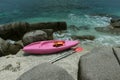 Pink kayak on coral beach