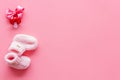 Pink knitted footwear and dummy for baby on pink background top view mockup Royalty Free Stock Photo
