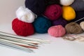 Colours balls of yarn and knitting needles on white backgroundhite background