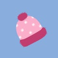 Pink knitted winter hat with pompom and snowflakes, flat vector. Winter hat on a blue background. Holiday card template. Royalty Free Stock Photo