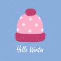 Pink knitted winter hat with pompom and snowflakes, flat vector. Winter hat on a blue background. Holiday card template Royalty Free Stock Photo