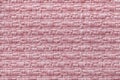 Pink knitted woolen background with a pattern of soft, fleecy cloth. Texture of textile closeup. Royalty Free Stock Photo