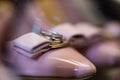 pink lacquer shoes close-up, on batik are rings for the newlyweds, wedding gatherings