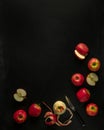 Pink lady apples, some cut with knife on black background with copy space Royalty Free Stock Photo