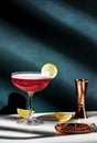 Pink lady classic cocktail drink with dry gin, grenadine syrup, lemon juice and egg white, dark green background, bright hard Royalty Free Stock Photo