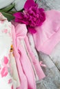 Pink layette for a newborn baby girl with peone