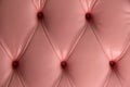 Pink leather background with big,bold buttons