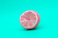 Pink lemon on a green background, the concept of changing yourself and your nature Royalty Free Stock Photo