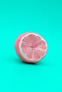 Pink lemon on a green background, the concept of changing yourself and your nature Royalty Free Stock Photo