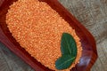 Pink lentil on wooden platter over rustic wooden table