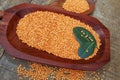 Pink lentil on wooden platter over rustic wooden table