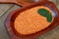 Pink lentil on wooden platter over rustic wooden table