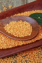 Pink lentil on wooden platter over rustic wooden table