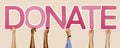 Pink letters forming the word donate Royalty Free Stock Photo