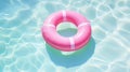 Pink lifebuoy on the water of the pool. View from above