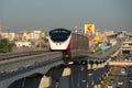 The Pink Line electric train runs on train tracks