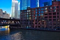 Pink line elevated `el` train on Lake Street Bridge in Chicago passes by the Merchandise Mart and over the Chicago River. Royalty Free Stock Photo