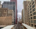 Pink line elevated `el` train pulling into the Adams and Wabash station